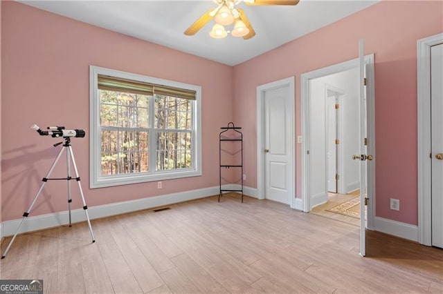 interior space with light wood-type flooring and ceiling fan