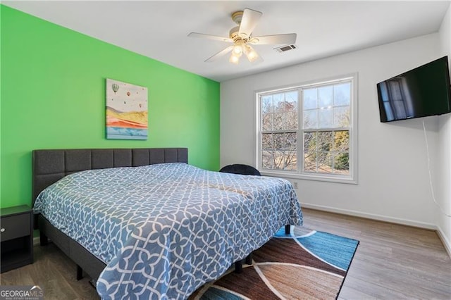 bedroom with hardwood / wood-style floors and ceiling fan