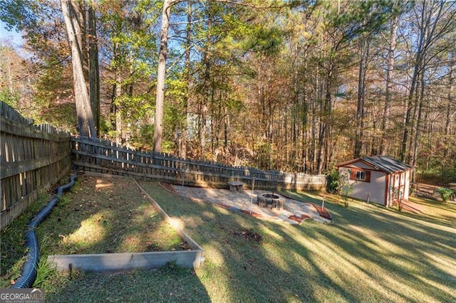 view of yard featuring an outbuilding and an outdoor fire pit