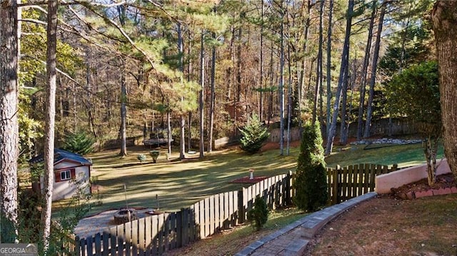 view of home's community with a storage shed and a yard