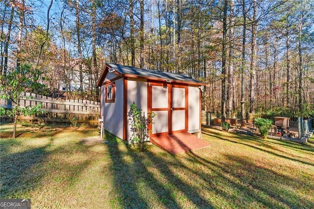 view of outbuilding featuring a lawn