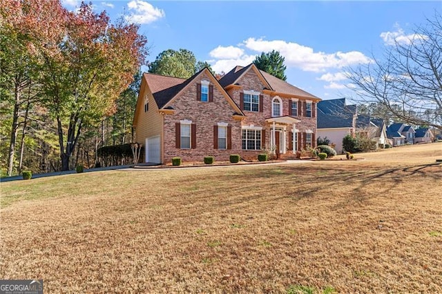 view of front of property with a garage and a front lawn