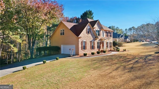 view of front facade with a front yard and a garage