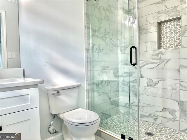 bathroom featuring vanity, toilet, and an enclosed shower