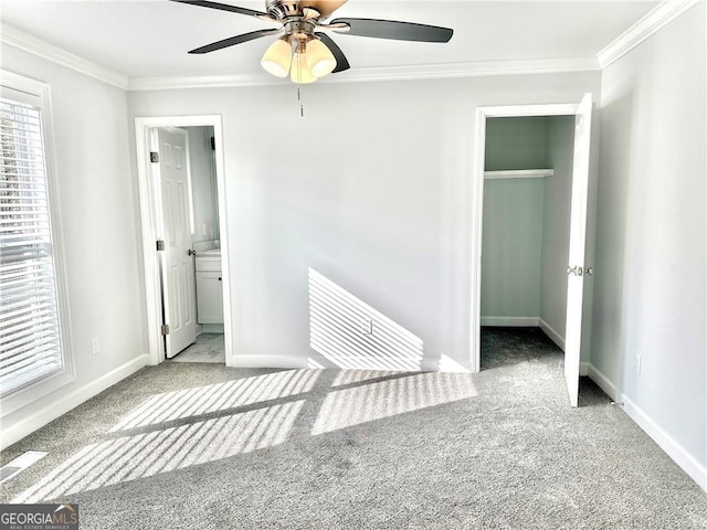 unfurnished bedroom with carpet flooring, ceiling fan, ensuite bathroom, and crown molding