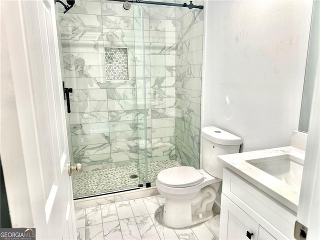 bathroom featuring an enclosed shower, vanity, and toilet