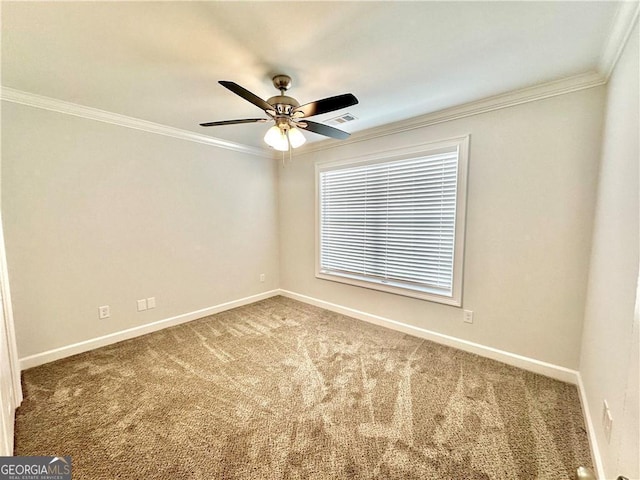 spare room featuring ceiling fan, carpet floors, and ornamental molding