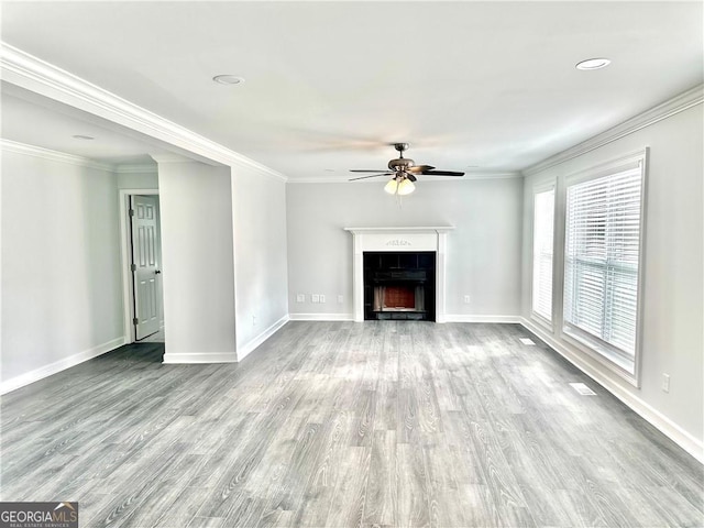 unfurnished living room with ceiling fan, light wood-type flooring, and crown molding