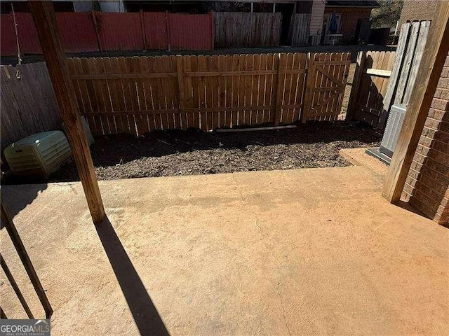 view of yard with central AC unit and a patio area