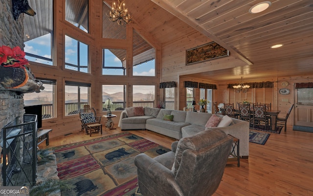 living room featuring a fireplace, hardwood / wood-style floors, a high ceiling, and plenty of natural light