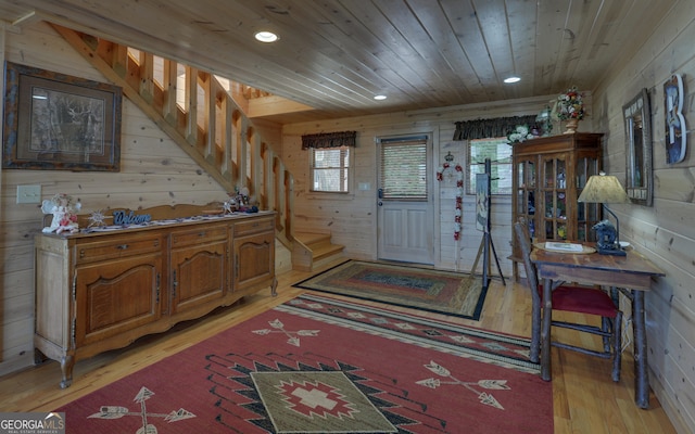 interior space with wooden ceiling, light hardwood / wood-style floors, and wooden walls