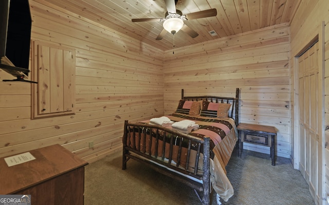 carpeted bedroom featuring wooden walls, ceiling fan, and wooden ceiling