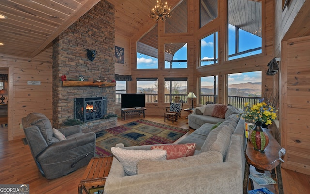 living room with a fireplace, high vaulted ceiling, wooden ceiling, and hardwood / wood-style flooring