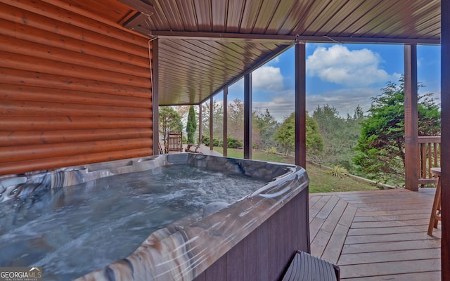 wooden deck with a hot tub