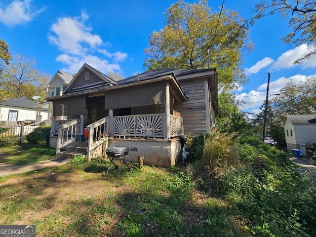 rear view of house with a porch