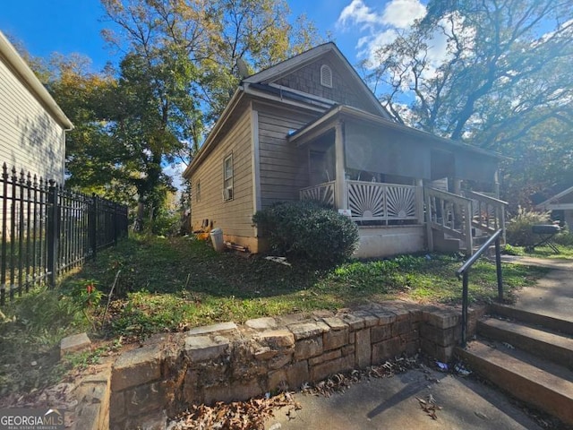 view of side of property with a porch