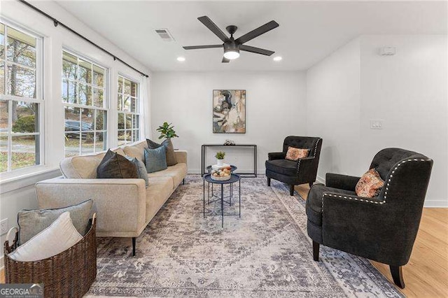 living room featuring hardwood / wood-style floors, plenty of natural light, and ceiling fan