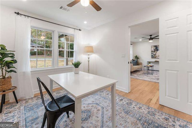 home office featuring light wood-type flooring and ceiling fan