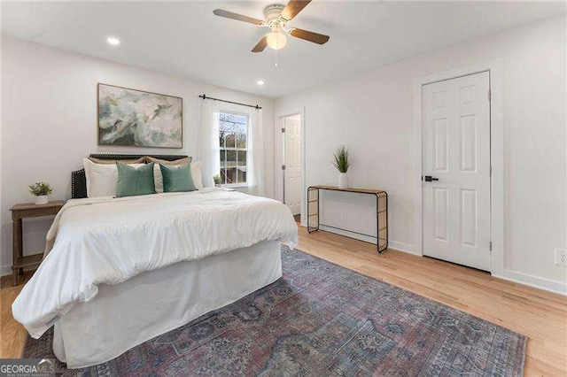 bedroom featuring hardwood / wood-style flooring and ceiling fan