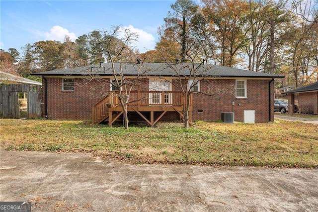 back of property featuring central AC unit, a deck, and a lawn