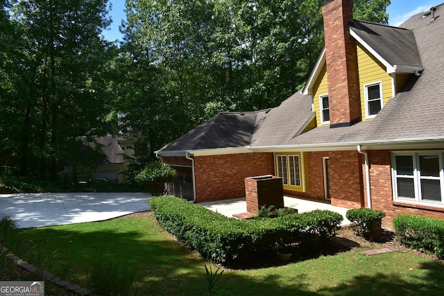 view of home's exterior with a yard