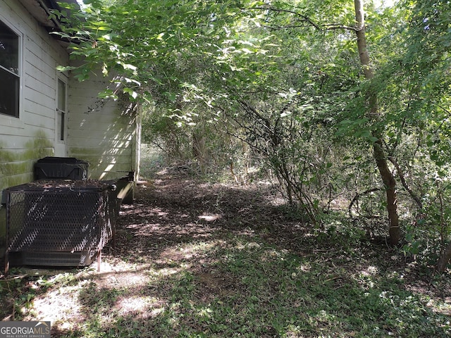 view of yard featuring central air condition unit