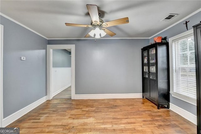 unfurnished room featuring hardwood / wood-style floors, ceiling fan, and ornamental molding