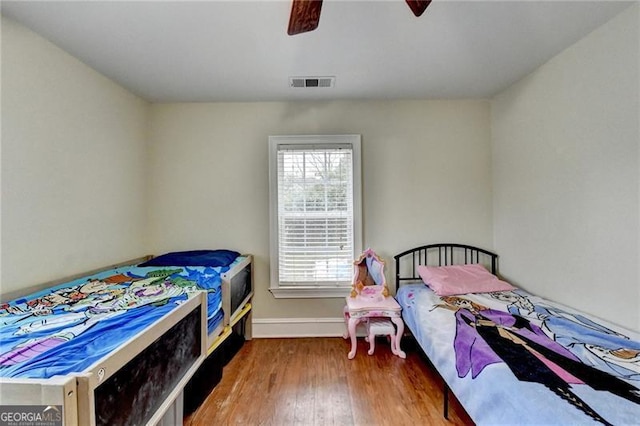 bedroom with ceiling fan and wood-type flooring