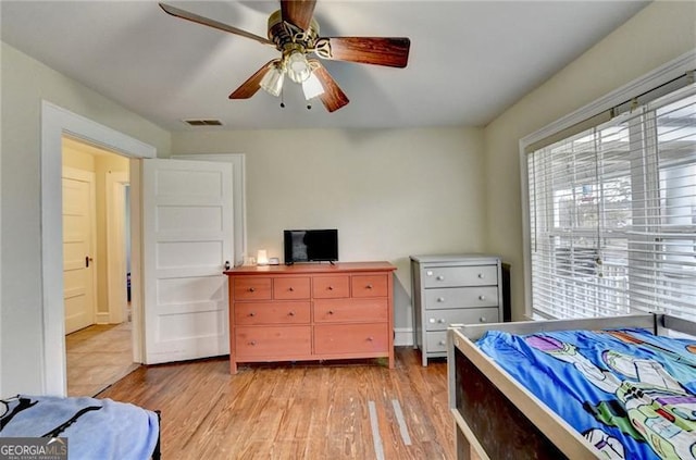 bedroom with ceiling fan and light hardwood / wood-style flooring