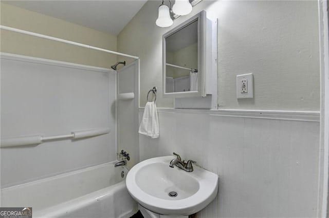 bathroom with shower / bathing tub combination and sink