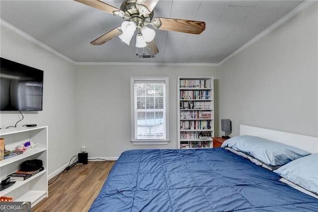 bedroom featuring ceiling fan, hardwood / wood-style floors, and ornamental molding