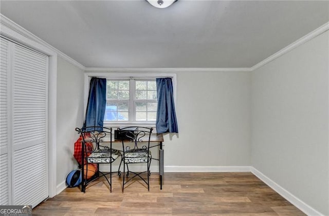 dining area featuring crown molding and hardwood / wood-style flooring