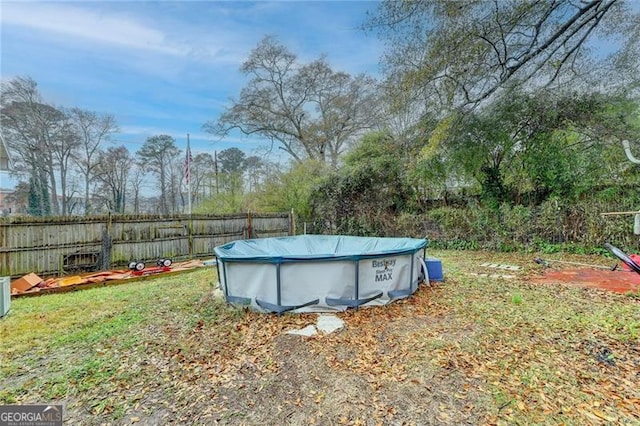 view of yard with a covered pool