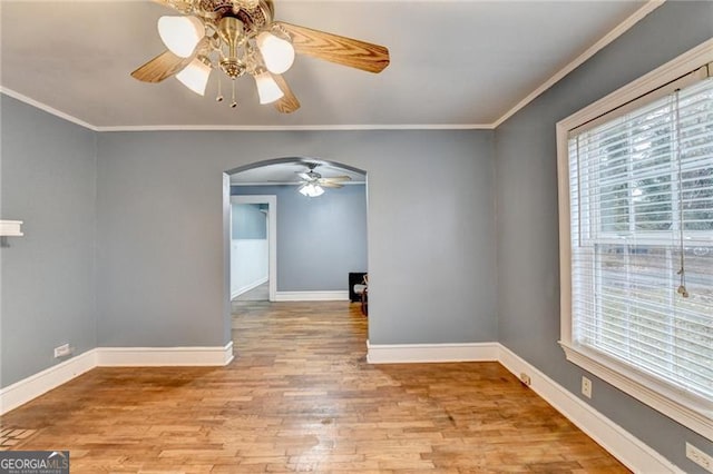 spare room with light hardwood / wood-style flooring, ceiling fan, and ornamental molding