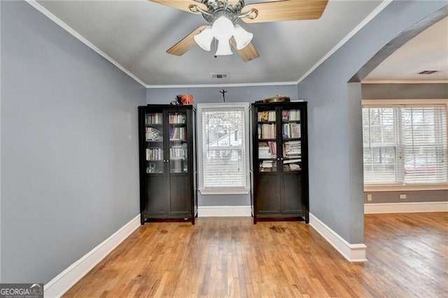 interior space featuring light hardwood / wood-style flooring, ceiling fan, and ornamental molding