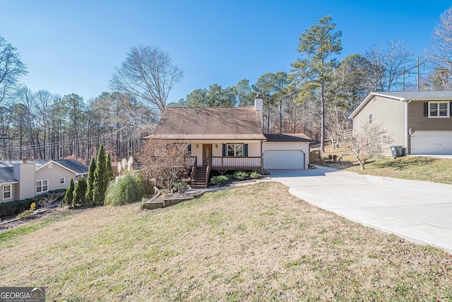 view of front facade with covered porch, a front yard, and a garage