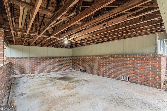 basement with brick wall