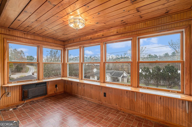 unfurnished sunroom with wooden ceiling