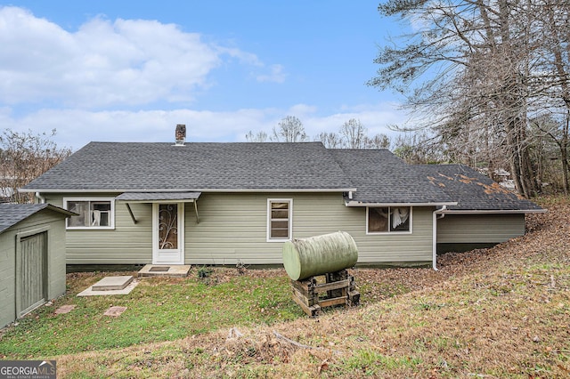 rear view of property featuring a yard