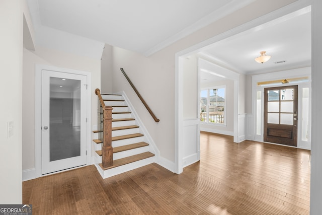 foyer featuring crown molding and hardwood / wood-style floors