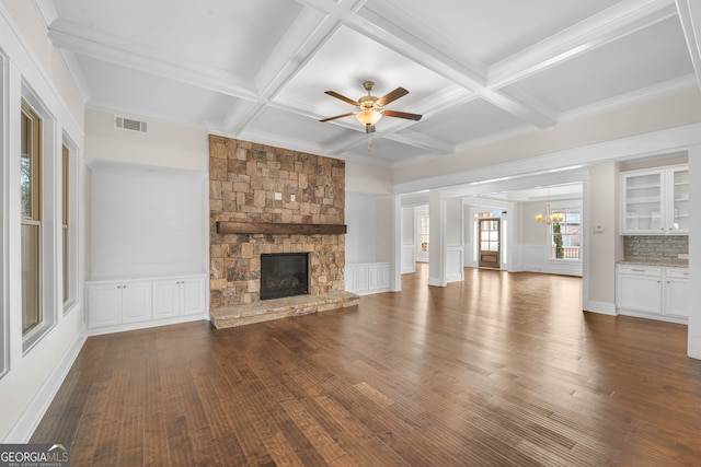 unfurnished living room with a fireplace, dark wood-type flooring, and coffered ceiling