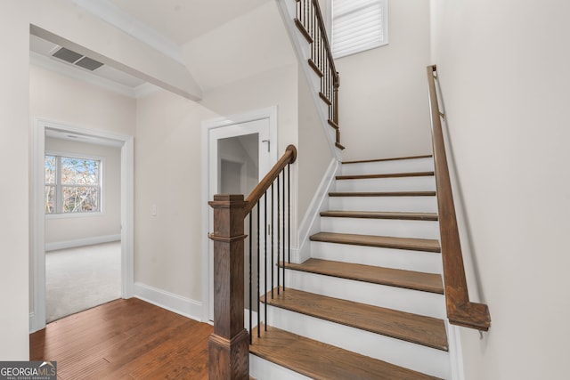 stairs with hardwood / wood-style flooring