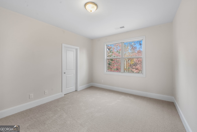 empty room featuring light carpet