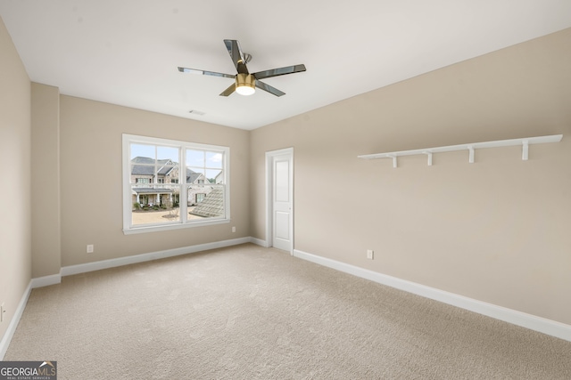 empty room with carpet and ceiling fan