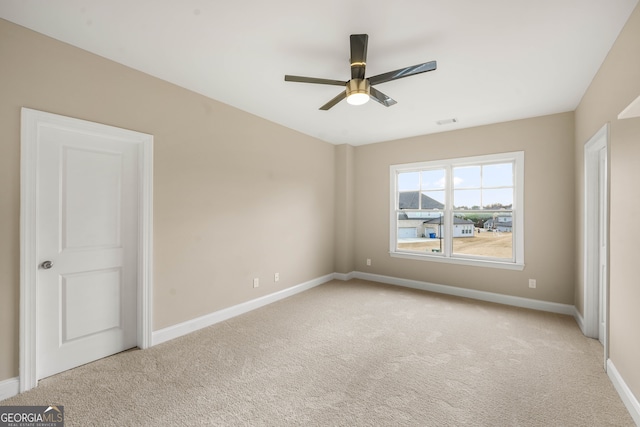 unfurnished bedroom featuring ceiling fan and light colored carpet