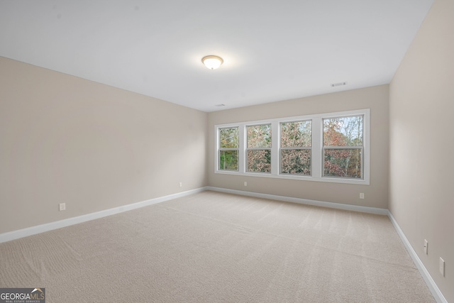 spare room with light colored carpet