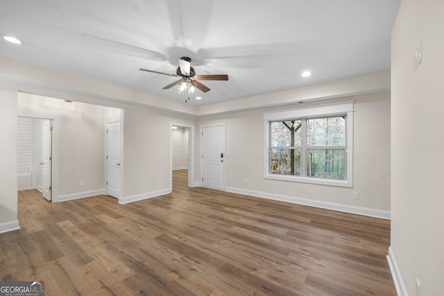 unfurnished room with ceiling fan and wood-type flooring