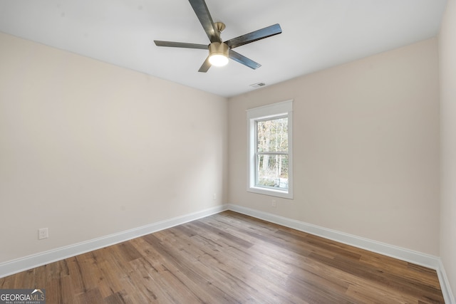 unfurnished room with ceiling fan and light wood-type flooring