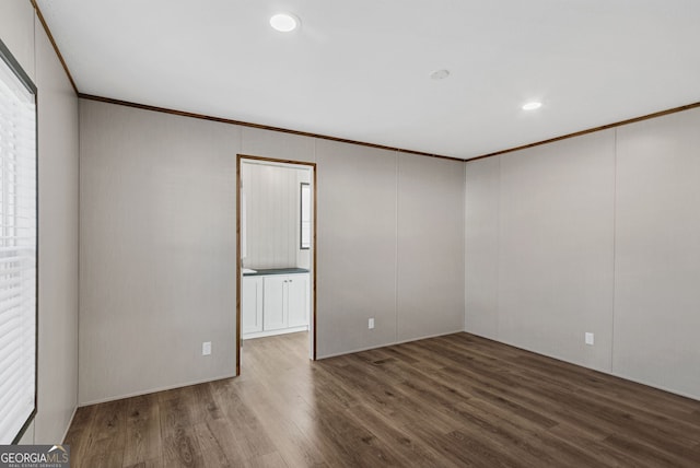 unfurnished room with hardwood / wood-style floors and ornamental molding