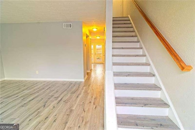 stairs with wood-type flooring